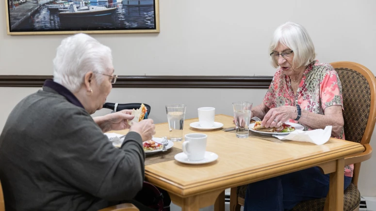 An elderly couple having breakfast at Duncan's retirement home